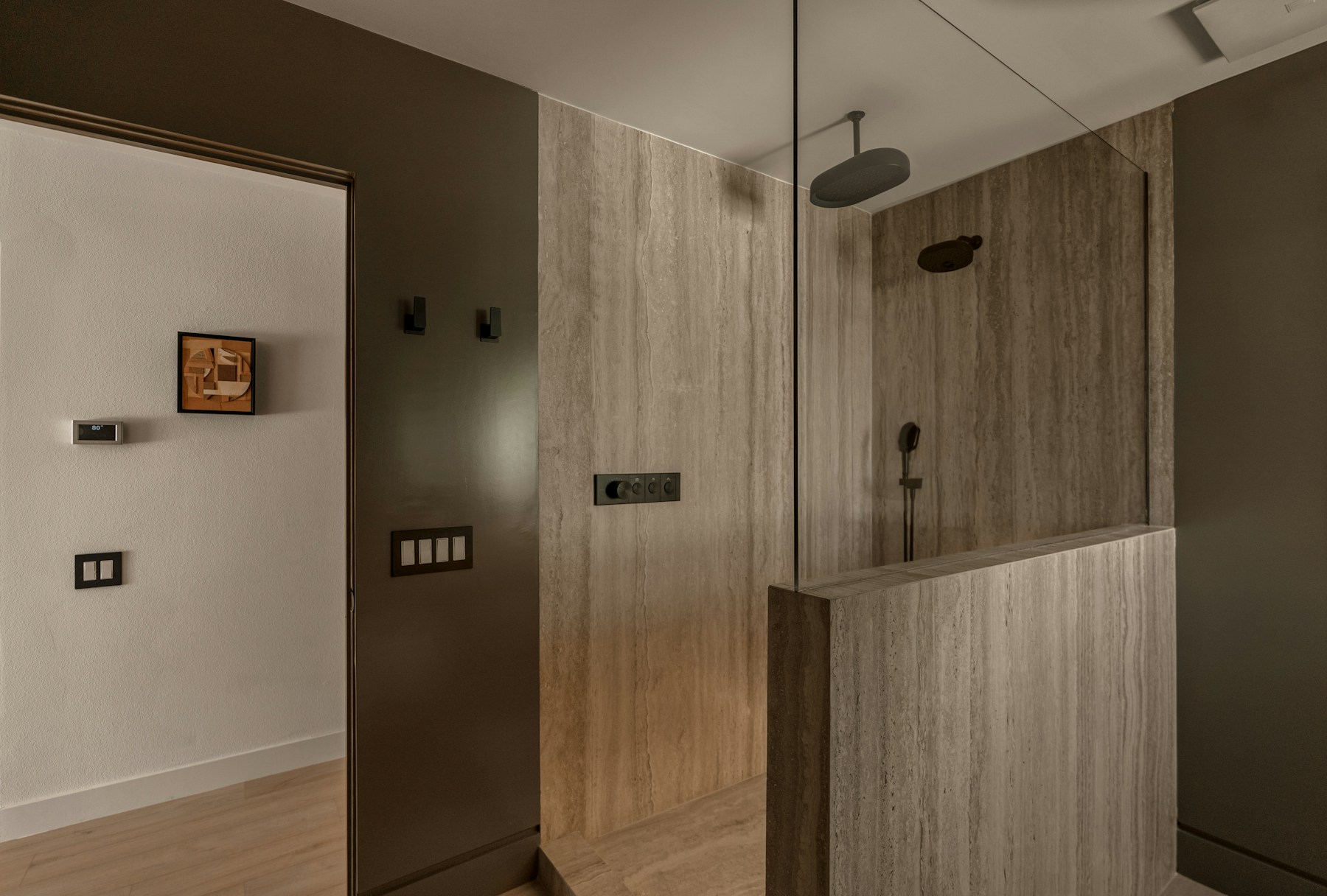 Warm stone and glass in an independent bathroom