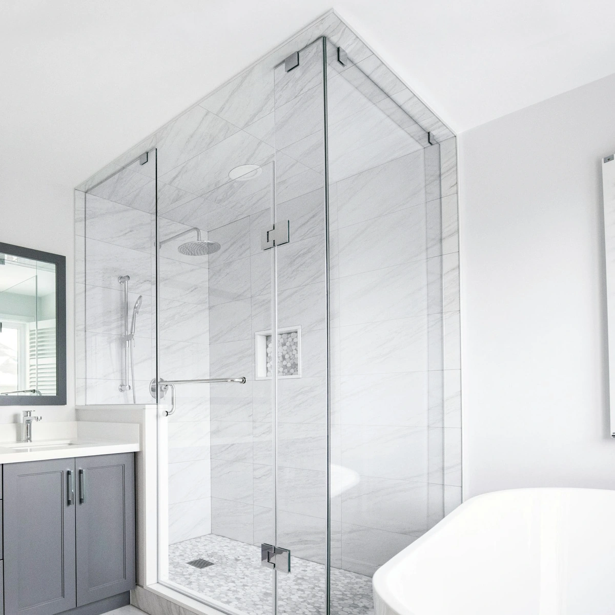 Glass shower enclosure in a light stone bathroom; general scene photography